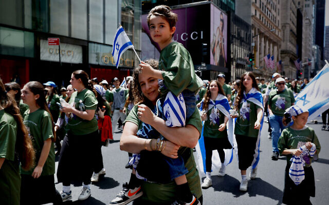 People carry Israeli flags as they participate in the Israel Day Parade in New York, on May 31, 2026. (Photo by Kena Betancur / AFP)