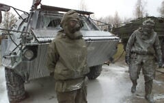 German Army soldiers next to a 'Fuchs' nuclear, biological and chemical detection tank covered with a decontamination liquid after a drill at the General Jaeger barracks in Sonthofen, southern Germany, November 19, 2001. (AP Photo/Diether Endlicher)