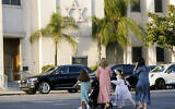 Illustrative: Mothers and daughters walk across from the Congregation Shaarei Tefila synagogue in Los Angeles on October 7, 2023.  (AP/Damian Dovarganes)