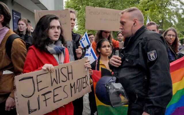 A woman carries a sign reading "Jewish lifes matter" when facing an anti-Israel, pro-Palestinian demonstration by the group "Student Coalition Berlin" in the theater courtyard of Freie Universität Berlin in Berlin, Germany, May 7, 2024. (AP Photo/Markus Schreiber)