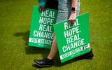Green Party supporters carry placards at their General Election Manifesto launch - Real Hope, Real Change, at Sussex County Cricket Ground in Hove, East Sussex, England, June 12, 2024.(Kirsty Wigglesworth/AP)