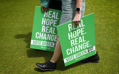 Green Party supporters carry placards at their General Election Manifesto launch - Real Hope, Real Change, at Sussex County Cricket Ground in Hove, East Sussex, England, June 12, 2024.(Kirsty Wigglesworth/AP)