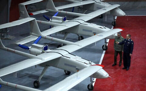 In this photo provided January 13, 2025, by the Iranian Army, Iranian Defense Minister Gen. Aziz Nasirzadeh, right, speaks with the army commander Gen. Abdolrahim Mousavi in a ceremony to deliver domestically-built drones to the army. (Iranian Army via AP)