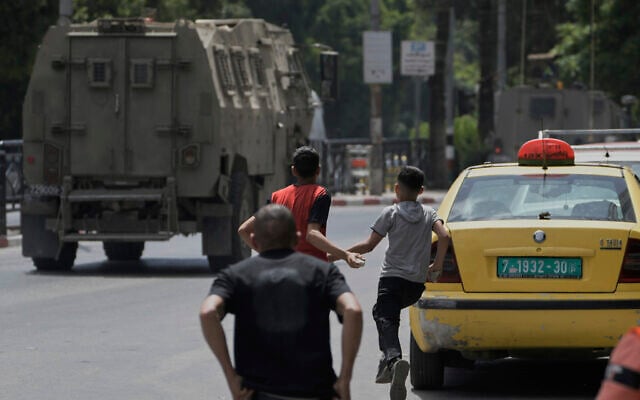 Young Palestinians prepare to throw stones at Israeli forces following a military raid in the West Bank city of Nablus, Tuesday, May 27, 2025. (AP Photo/Majdi Mohammed) Young Palestinians prepare to throw stones at Israeli forces following a military raid in the West Bank city of Nablus, Tuesday, May 27, 2025. (AP Photo/Majdi Mohammed)