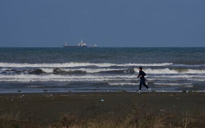 A man jogs along the southern coast of the Caspian Sea in the port city of Bandar Anzali, Iran, Decenmber 21, 2025. (AP Photo/Vahid Salemi)
