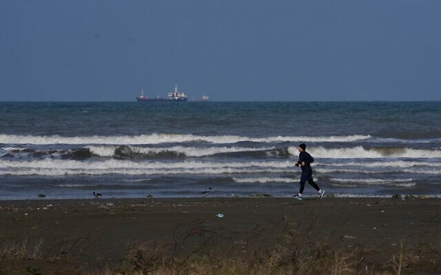 A man jogs along the southern coast of the Caspian Sea in the port city of Bandar Anzali, Iran, Decenmber 21, 2025. (AP Photo/Vahid Salemi)