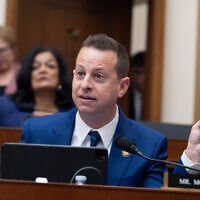 US Rep. Jared Moskowitz, D-Fla., holds up a Trump Bible as he questions Attorney General Pam Bondi in the House Judiciary Committee at the Capitol in Washington, February 11, 2026. (AP Photo/J. Scott Applewhite)