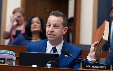 US Rep. Jared Moskowitz, D-Fla., holds up a Trump Bible as he questions Attorney General Pam Bondi in the House Judiciary Committee at the Capitol in Washington, February 11, 2026. (AP Photo/J. Scott Applewhite)