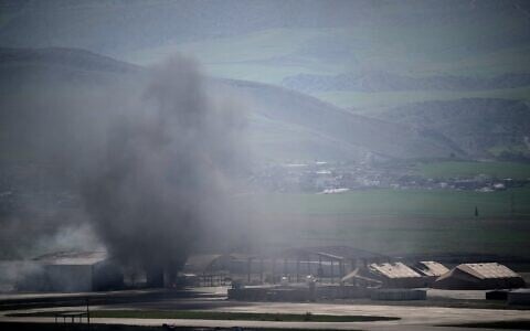 Smoke rises to the sky at an air base following attacks early morning, in Harir, Iraq, March 12, 2026. (AP/Leo Correa)
