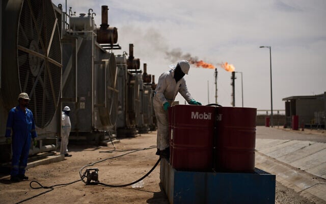 Illustrative: A worker collects engine oil as he works at a degassing station in the Zubair oil field near Basra, Iraq, on March 28, 2026. (AP Photo/Leo Correa) Illustrative: A worker collects engine oil as he works at a degassing station in the Zubair oil field near Basra, Iraq, on March 28, 2026. (AP Photo/Leo Correa)
