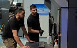 Workers operate a 3D printer that makes drone parts at the headquarters of Masssivit in Lod, on March 30, 2026. (AP Photo/Ohad Zwigenberg)