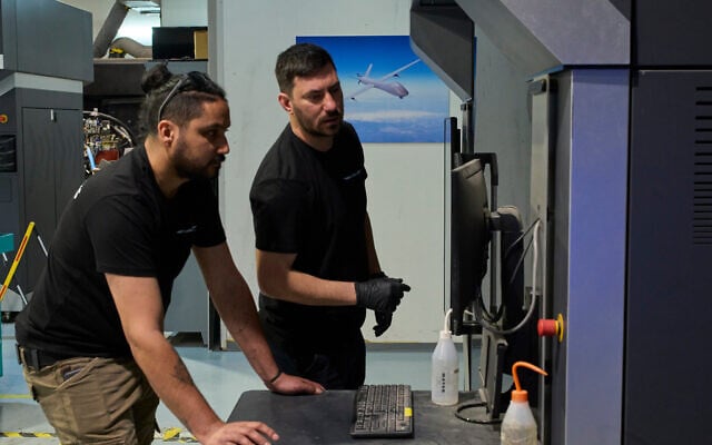 Workers operate a 3D printer that makes drone parts at the headquarters of Masssivit in Lod, on March 30, 2026. (AP Photo/Ohad Zwigenberg)