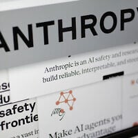 Pages from the Anthropic website and the company's logo are displayed on a computer screen in New York on February 26, 2026. (AP Photo/Patrick Sison)