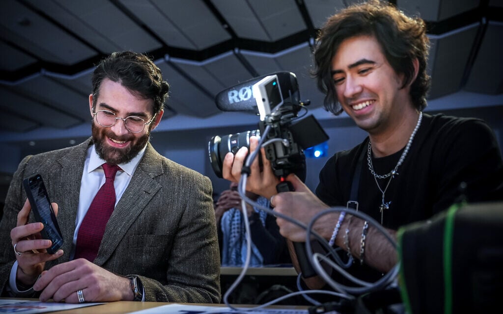 Streamer Hasan Piker, left, shows his phone on a live Twitch stream as producer Mauricio Miranda films during a campaign event for Abdul El-Sayed, a progressive candidate in the Democratic primary for US Senate in Michigan, Tuesday, April 7, 2026, at the University of Michigan in Ann Arbor, Mich. (AP/Julia Demaree Nikhinson) Streamer Hasan Piker, left, shows his phone on a live Twitch stream as producer Mauricio Miranda films during a campaign event for Abdul El-Sayed, a progressive candidate in the Democratic primary for US Senate in Michigan, Tuesday, April 7, 2026, at the University of Michigan in Ann Arbor, Mich. (AP/Julia Demaree Nikhinson)