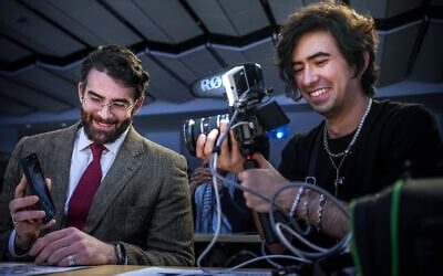 Streamer Hasan Piker, left, shows his phone on a live Twitch stream as producer Mauricio Miranda films during a campaign event for Abdul El-Sayed, a progressive candidate in the Democratic primary for US Senate in Michigan, Tuesday, April 7, 2026, at the University of Michigan in Ann Arbor, Mich. (AP/Julia Demaree Nikhinson)