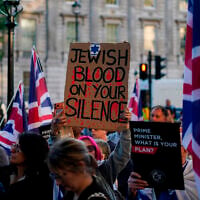 Protesters gather near Downing Street during a 'national emergency' rally organized by the Campaign Against Antisemitism following a terror stabbing attack in Golders Green, London, April 30, 2026. (AP Photo/Alberto Pezzali)