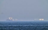 A tanker, left, and a car carrier are anchored at sea in the Gulf of Oman near the Strait of Hormuz, as seen from the coast near Khor Fakkan, United Arab Emirates, May 1, 2026.(AP/Fatima Shbair)