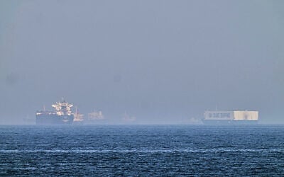 A tanker, left, and a car carrier are anchored at sea in the Gulf of Oman near the Strait of Hormuz, as seen from the coast near Khor Fakkan, United Arab Emirates, May 1, 2026.(AP/Fatima Shbair)