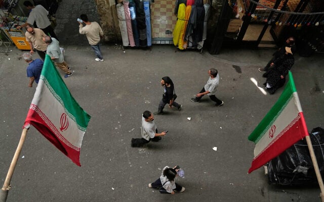 People walk as Iranian flags hang in the Grand Bazaar in Tehran, Iran, May 3, 2026. (AP/Vahid Salemi) People walk as Iranian flags hang in the Grand Bazaar in Tehran, Iran, May 3, 2026. (AP/Vahid Salemi)