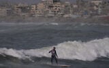 Palestinian Tahseen Abu Assi rides a wave at a beach along the Mediterranean Sea in Gaza City, Monday, May 4, 2026. (AP Photo/Jehad Alshrafi)