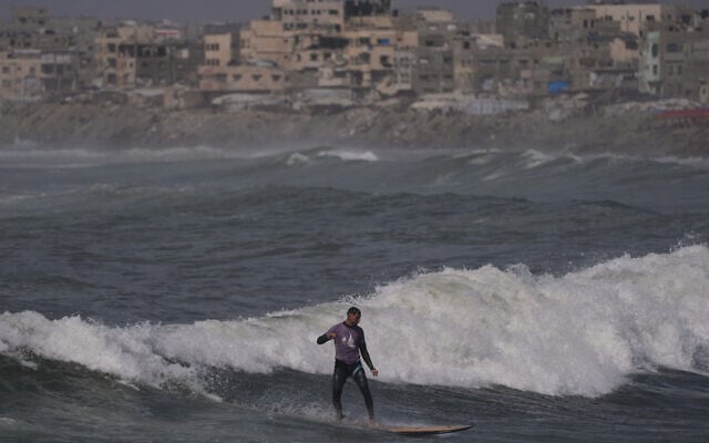 Palestinian Tahseen Abu Assi rides a wave at a beach along the Mediterranean Sea in Gaza City, Monday, May 4, 2026. (AP Photo/Jehad Alshrafi) Palestinian Tahseen Abu Assi rides a wave at a beach along the Mediterranean Sea in Gaza City, Monday, May 4, 2026. (AP Photo/Jehad Alshrafi)