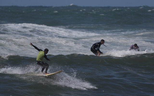 Palestinian Khalil Abu Jayyab rides a wave at a beach along the Mediterranean Sea in Gaza City, Monday, May 4, 2026. (AP Photo/Jehad Alshrafi)