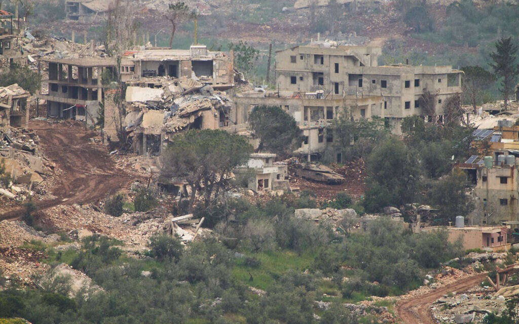 IDF soldiers drive a tank inside a village in southern Lebanon, as seen from northern Israel, May 5, 2026. (AP Photo/Ariel Schalit)