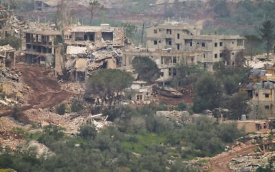 IDF soldiers drive a tank inside a village in southern Lebanon, as seen from northern Israel, May 5, 2026. (AP Photo/Ariel Schalit)