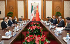 In this photo released by Xinhua News Agency, Chinese Foreign Minister Wang Yi, second right, talks to his Iranian counterpart Abbas Araghchi, left, during a bilateral meeting in Beijing, on May 6, 2026. (Cai Yang/Xinhua via AP)