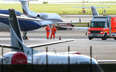 Medical personnel in hazmat suits wait for patients, evacuated from the MV Hondius cruise ship with suspected hantavirus infection, at Schiphol airport, Amsterdam, Netherlands, May 6, 2026. (AP/Peter Dejong)