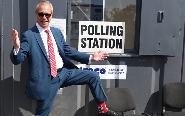 Britain's Reform Party leader Nigel Farage shows his socks as he arrives at a polling station in Walton on the Naze, England, May 7, 2026 to cast his vote in the local elections.(AP Photo/Richard Pelham)