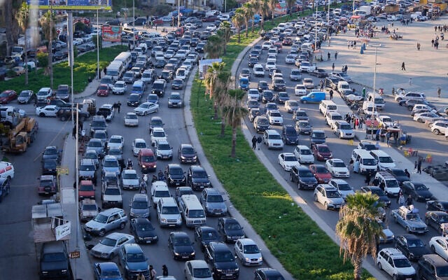 Displaced people fleeing Israeli strikes in southern Lebanon sit in traffic at a highway that links to Beirut, in the southern port city of Sidon, March 2, 2026. (AP/Mohammed Zaatari)