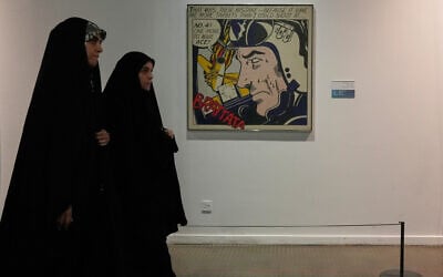 Iranian women walk past American-Jewish artist Roy Lichtenstein's 'Brattata' as they visit an exhibition called: 'Art & war' displaying some artworks of American pop artists at the Tehran Museum of Contemporary Art in Iran, on May 7, 2026. (AP Photo/Vahid Salemi)