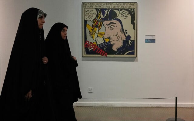 Iranian women walk past American-Jewish artist Roy Lichtenstein's 'Brattata' as they visit an exhibition called: 'Art & war' displaying some artworks of American pop artists at the Tehran Museum of Contemporary Art in Iran, on May 7, 2026. (AP Photo/Vahid Salemi)