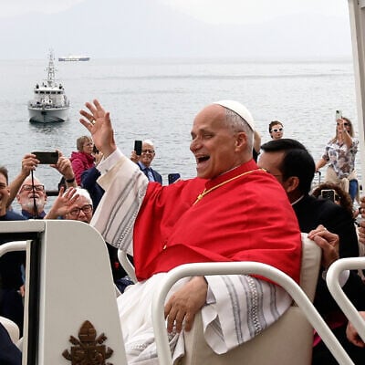 Pope Leo XIV, riding in the popemobile with Cardinal Domenico Battaglia, right, travels along the seafront in Naples, May 8, 2026 (AP Photo/Salvatore Laporta)