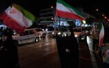 Women hold Iranian flags for a pro-government campaign in downtown Tehran, Iran, May 8, 2026. (AP/Vahid Salemi)