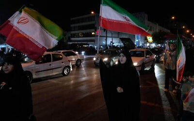 Women hold Iranian flags for a pro-government campaign in downtown Tehran, Iran, May 8, 2026. (AP/Vahid Salemi)