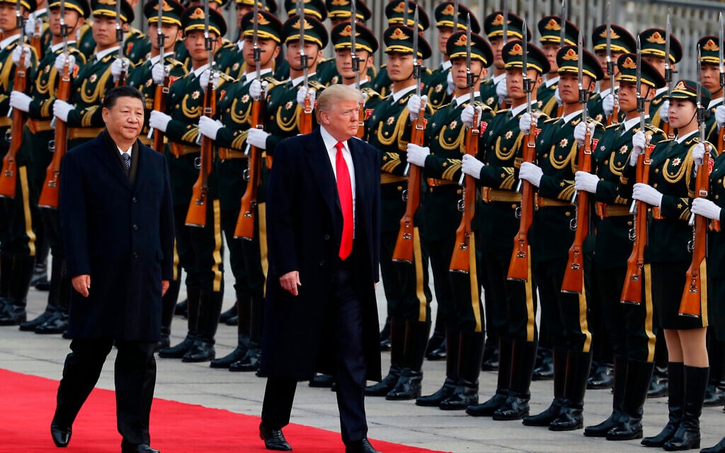 US President Donald Trump, right, and Chinese President Xi Jinping inspect a honor guard during a welcome ceremony at the Great Hall of the People in Beijing, November 9, 2017. (AP Photo/Andy Wong, File)