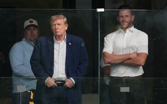 US President Donald Trump and Eric Trump watch the Maaden LIV Golf Virginia tournament at Trump National Golf Club, May 9, 2026, in Sterling, Virginia. (AP Photo/Alex Brandon)