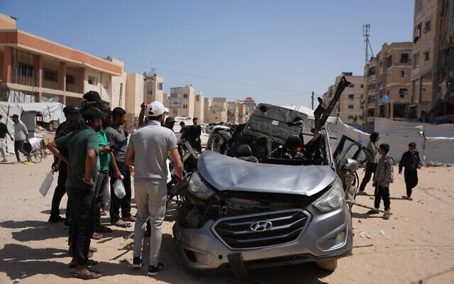 Palestinians inspect a vehicle struck by an Israeli airstrike in Khan Younis, in the southern Gaza Strip, May 10, 2026. (AP Photo/Abdel Kareem Hana)