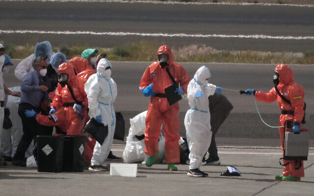 Passengers are sprayed with disinfectant by Spanish government officials before boarding a plane after disembarking from the hantavirus-stricken cruise ship MV Hondius at Tenerife airport in the Canary Islands, Spain, Sunday, May 10, 2026. (AP Photo/Arturo Rodriguez) Passengers are sprayed with disinfectant by Spanish government officials before boarding a plane after disembarking from the hantavirus-stricken cruise ship MV Hondius at Tenerife airport in the Canary Islands, Spain, Sunday, May 10, 2026. (AP Photo/Arturo Rodriguez)
