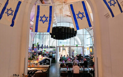 Israeli flags hang in the designated Israel "Euro Cafe" MQ Kantine during the 70th Eurovision Song Contest week in Vienna, Austria, May 13, 2026. (AP/Martin Meissner)