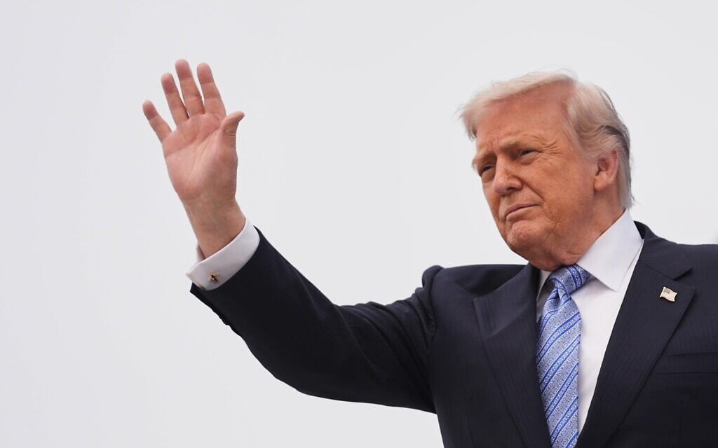 US President Donald Trump waves as he boards Air Force One, Friday, May 15, 2026, at Beijing Capital International Airport in Beijing. (AP Photo/Mark Schiefelbein)