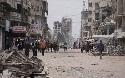 Palestinians walk along a street surrounded by buildings destroyed during the Israel-Hamas war, in Gaza City, Friday, May 15, 2026. (AP Photo/Abdel Kareem Hana) Palestinians walk along a street surrounded by buildings destroyed during the Israel-Hamas war, in Gaza City, Friday, May 15, 2026. (AP Photo/Abdel Kareem Hana)