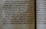A rare, long-lost copy of Caedmon's Hymn — the oldest surviving poem in Old English — is visible in the five lines above the final line of a page from an 8th-century manuscript copy of the Venerable Bede's Ecclesiastical History of the English People, at Rome's National Library, May 8, 2026. (AP Photo/Andrea Rosa)