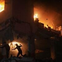 Palestinians react to a fire following an Israeli strike on a residential building in the Rimal neighborhood of Gaza City, Friday, May 15, 2026. (AP Photo/Jehad Alshrafi)