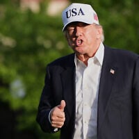 US President Donald Trump gestures to reporters as he walks across the South Lawn of the White House, May 15, 2026, in Washington. (AP Photo/Jacquelyn Martin)