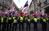Police forces stand in front of the far right Unite the Kingdom march in London, Saturday, May 16, 2026. (AP Photo/Kirsty Wigglesworth)