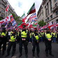Police forces stand in front of the far right Unite the Kingdom march in London, Saturday, May 16, 2026. (AP Photo/Kirsty Wigglesworth)