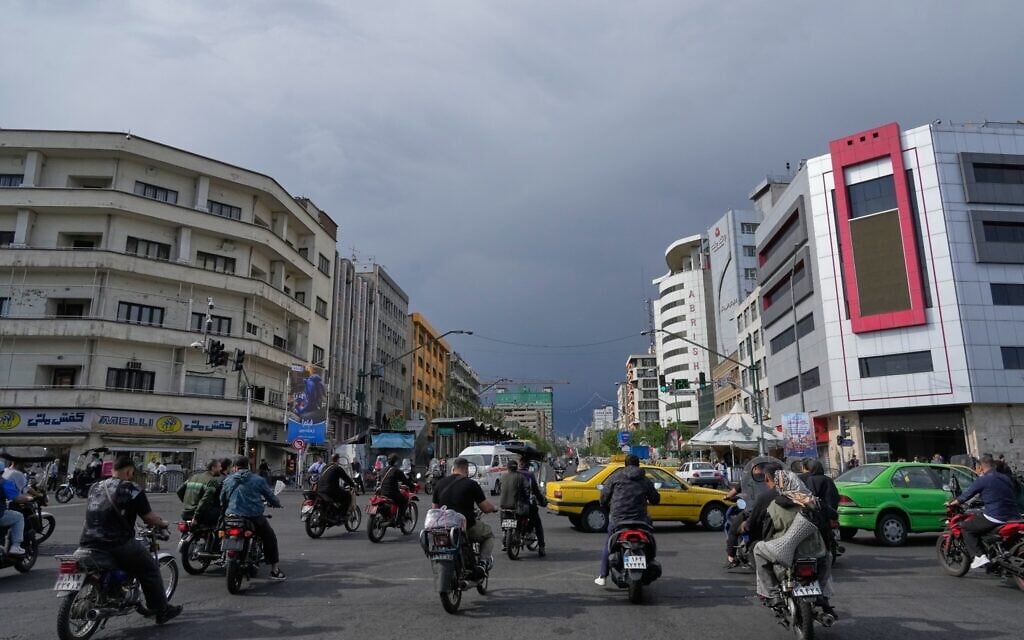 Motorbikes and cars pass through an intersection in downtown Tehran, Iran, May 17, 2026. (AP/Vahid Salemi)